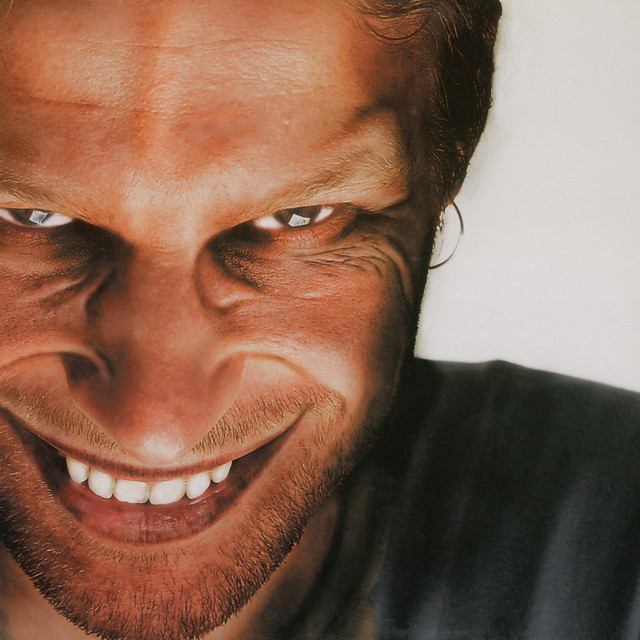 Richard D. James Album β Aphex Twin (1996). The album named after the alias named after its maker. The cover photograph β James grinning directly at the camera β became the mask worn by the feral children in the Chris Cunningham video for 'Come to Daddy' a year later.