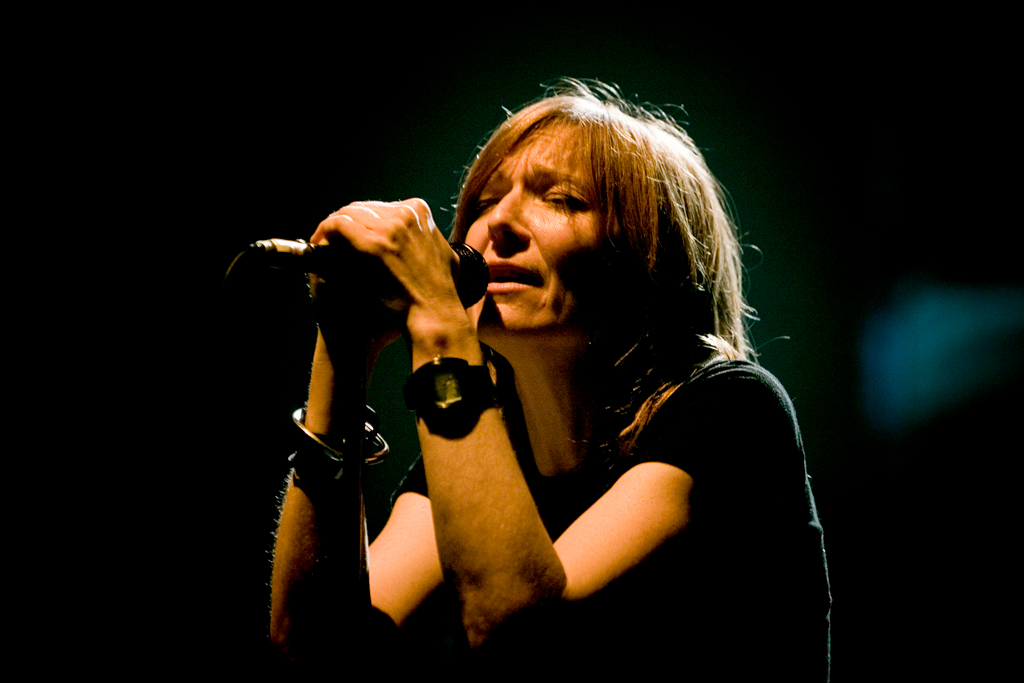 Beth Gibbons performing with Portishead. Her vocal was the constant across Dummy — Barrow's beats and Utley's guitar were built around it.